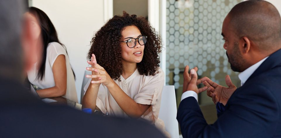 Businesspeople explaining and listening at meeting